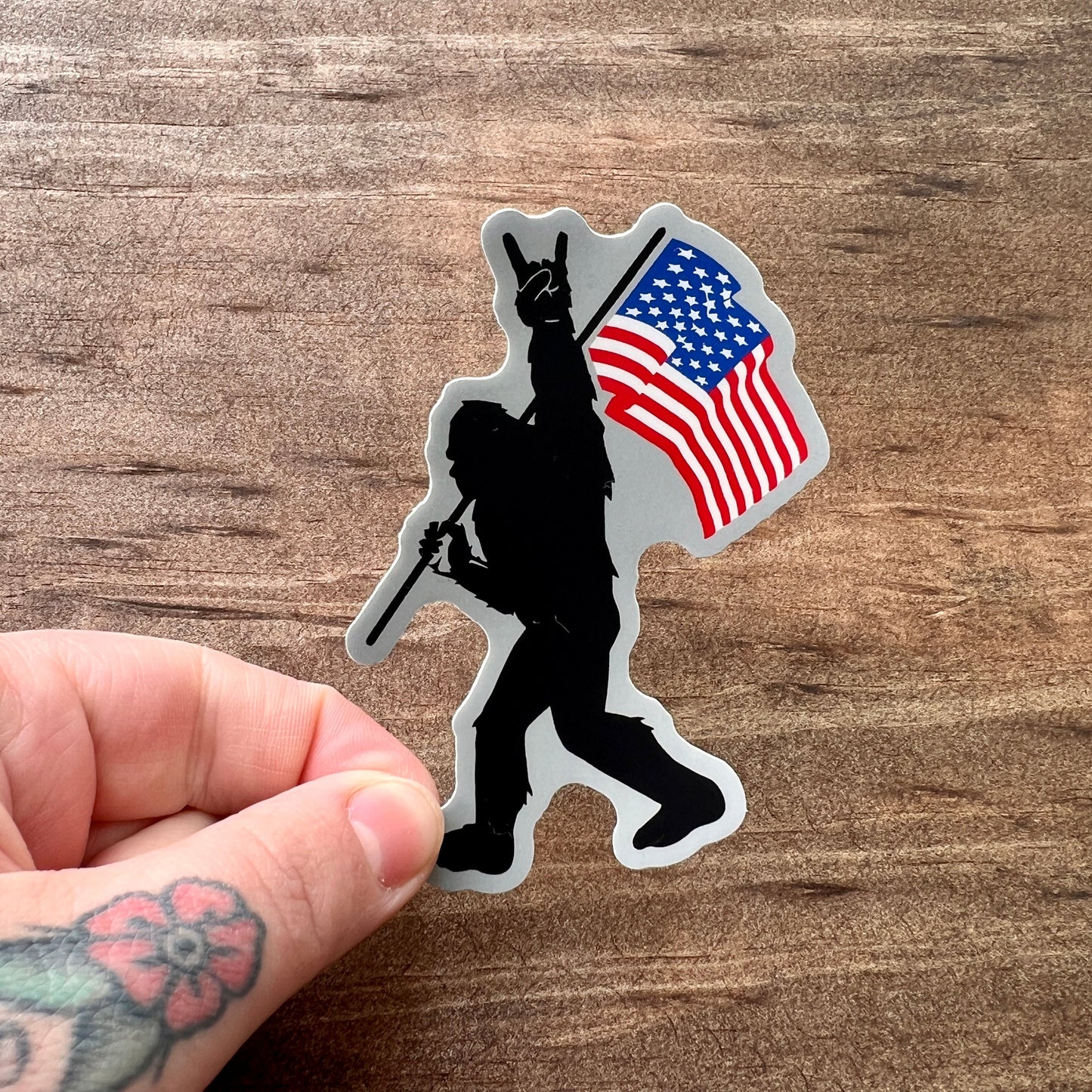 Bigfoot Carrying Flag Sticker by 208 Tees